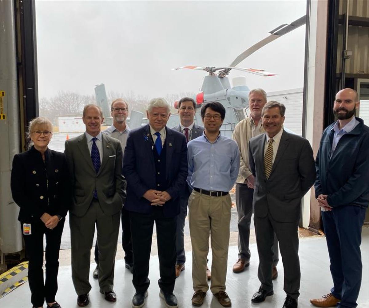 Rep. Larson and the Kaman team in front of the K-MAX helicopter