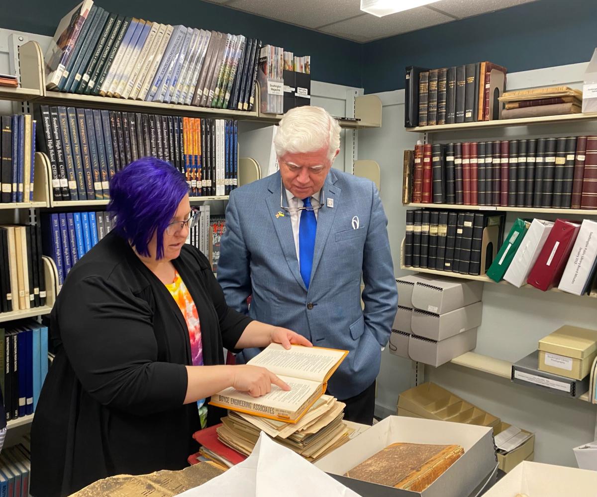 Larson looks at library archives with Reference Librarian Lynn Gardner