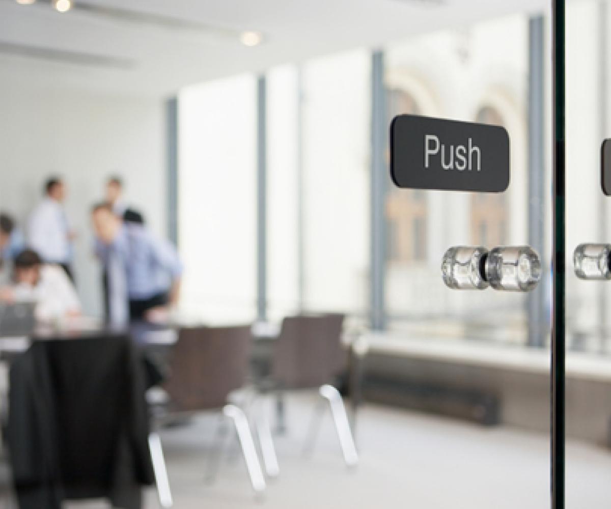 Office meeting behind glass doors