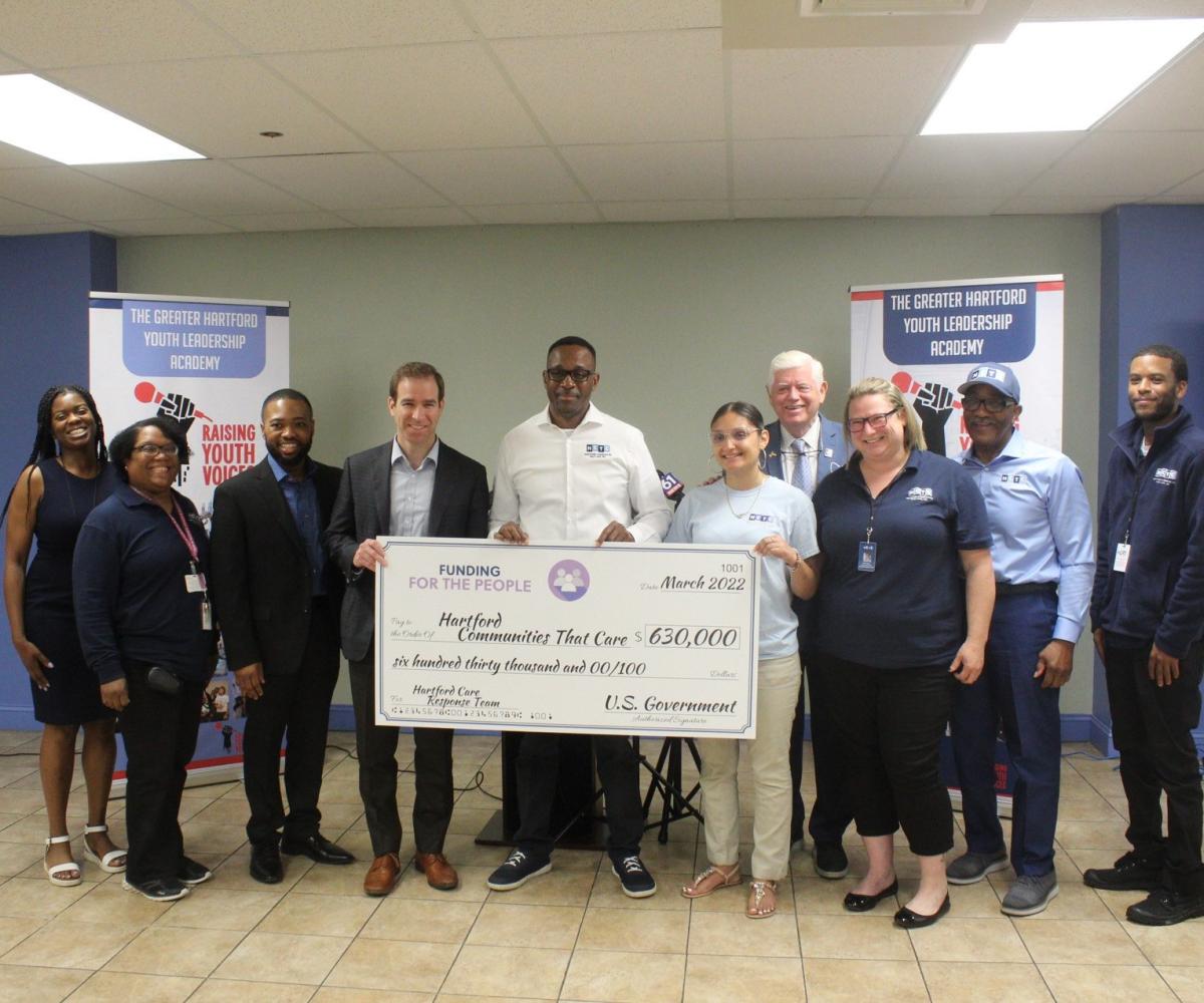Hartford Mayor Luke Bronin, Hartford Communities That Care Executive Director Andrew Woods, and Rep. Larson 