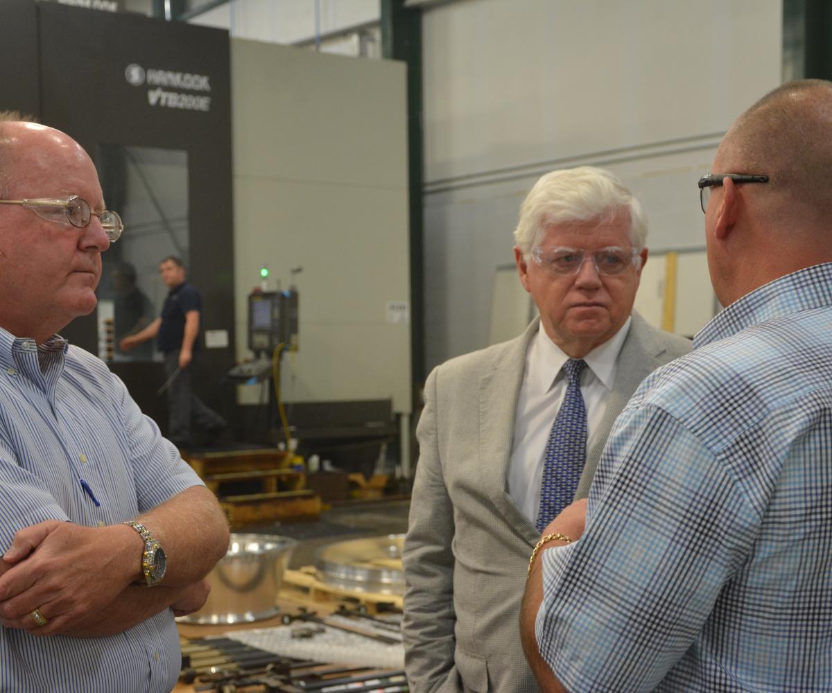 Kevin Flanagan (left), Rep. Larson (center), and Michael Flanagan (right) discuss operations.