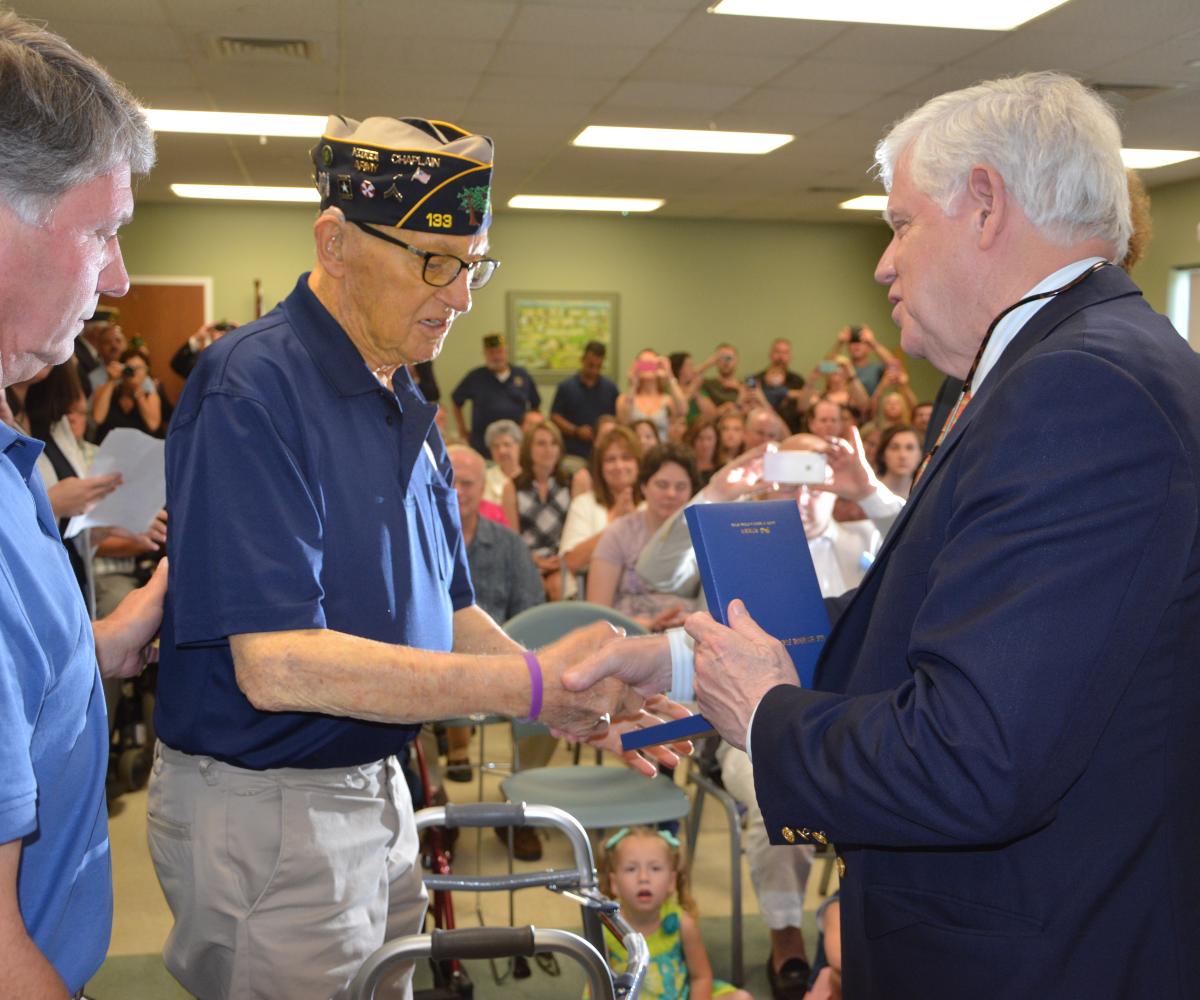 Rep. Larson presents Corporal Clifford “Bruce” Daugherty with the Korean Ambassador for Peace Medal.