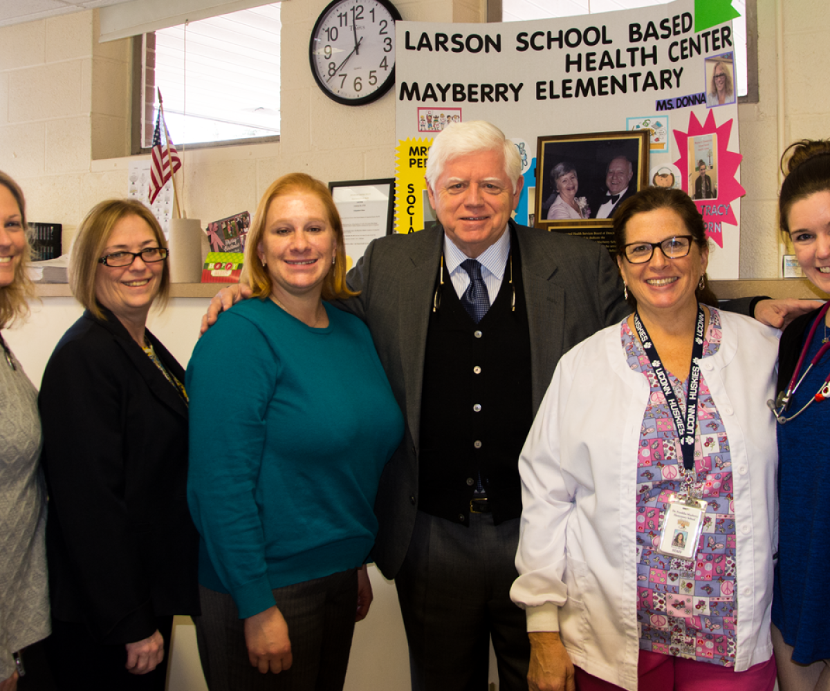 Rep. Larson stands with the staff of the health center at Mayberry Elementary. 