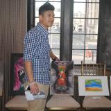 Jensun Yonjan stands with his winning piece, "Evanescent"