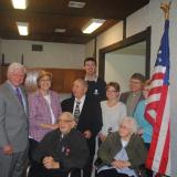 Larson stands with Mr. and Mrs. Luszczak, their son Tom, and other family and friends 