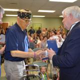Rep. Larson presents Corporal Clifford “Bruce” Daugherty with the Korean Ambassador for Peace Medal.
