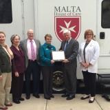 Larson presents the Nancy Pilver Award to Malta House of Care