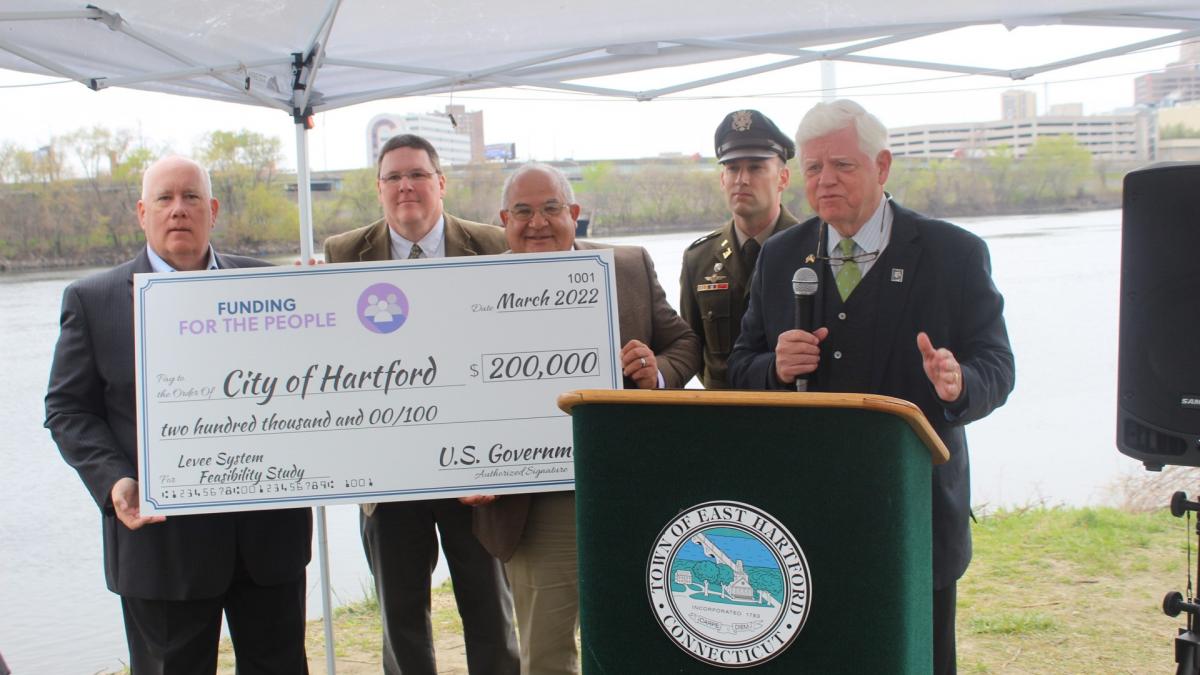 East Hartford Mayor Mike Walsh, East Hartford Town Engineer Douglas Wilson, Hartford City Engineer and Assistant Director of Public Works Frank Dellaripa, Lt. Colonel Michael Carvelli of the U.S. Army Corps of Engineers, and Rep. Larson in front of the Connecticut River