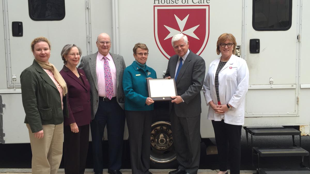 Larson presents the Nancy Pilver Award to Malta House of Care