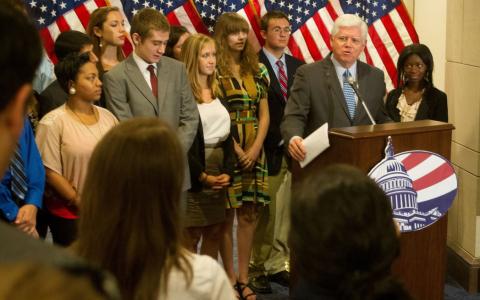 Congressman Larson behind the podium with a group of people